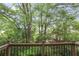 A lovely wooden balcony overlooks a lush green wooded area with homes in the background at 249 Sycamore Pl, Decatur, GA 30030