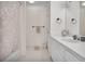Bright bathroom with white tiles, modern sink, and shower with a curtain at 249 Sycamore Pl, Decatur, GA 30030