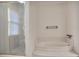 Bathroom featuring step up bathtub, tiled shower and tub surround, and bright light at 249 Sycamore Pl, Decatur, GA 30030