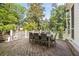 Outdoor deck space, ideal for entertaining or relaxing, with dining table and wooded views at 304 Meadowbrook Ne Dr, Atlanta, GA 30342