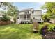 Well-manicured backyard with a white exterior, screened porch, deck, and stylish outdoor seating at 304 Meadowbrook Ne Dr, Atlanta, GA 30342