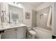 Bathroom featuring a shower-tub combination with gray tiling, marble vanity, and modern finishes at 304 Meadowbrook Ne Dr, Atlanta, GA 30342