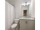 Bathroom featuring gray countertops, white cabinets, and a shower with a white curtain at 304 Meadowbrook Ne Dr, Atlanta, GA 30342