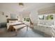 Bright bedroom featuring stylish decor, large windows, and a cozy window seat with built-in storage at 304 Meadowbrook Ne Dr, Atlanta, GA 30342