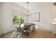 Bright dining room features a modern light fixture, hardwood floors and a view of the backyard at 304 Meadowbrook Ne Dr, Atlanta, GA 30342