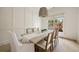 Bright dining area featuring a decorative chandelier, textured pendant lighting, and a large sunlit window at 304 Meadowbrook Ne Dr, Atlanta, GA 30342