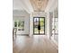 Bright, airy foyer with hardwood floors, contemporary lighting, and a grand front door with sidelights at 304 Meadowbrook Ne Dr, Atlanta, GA 30342