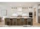 Kitchen island with bar seating, stylish pendants, stainless appliances, and ample counter space at 304 Meadowbrook Ne Dr, Atlanta, GA 30342