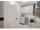 Laundry room with white cabinets, a washer, dryer, and door with black hardware at 304 Meadowbrook Ne Dr, Atlanta, GA 30342