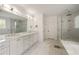 Elegant main bathroom featuring marble countertops, dual sinks, and a glass-enclosed shower at 304 Meadowbrook Ne Dr, Atlanta, GA 30342