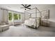 Spacious main bedroom boasts a canopy bed, sitting area, and large windows for ample natural light at 304 Meadowbrook Ne Dr, Atlanta, GA 30342