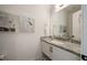 Elegant powder room featuring granite countertops, a decorative mirror, and stylish wall art at 304 Meadowbrook Ne Dr, Atlanta, GA 30342