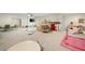 Spacious recreation room with neutral carpet, TV, seating, and play areas at 304 Meadowbrook Ne Dr, Atlanta, GA 30342