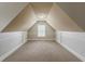 Finished attic space with carpeted floors and symmetrical sloped ceilings at 3912 Margaux Dr, Atlanta, GA 30349
