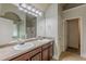 Bathroom features a double sink vanity with wooden cabinets and a large mirror and separate shower at 3912 Margaux Dr, Atlanta, GA 30349