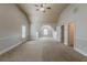 This bedroom features neutral paint, vaulted ceiling, and windows with natural light, and door at 3912 Margaux Dr, Atlanta, GA 30349