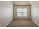 This bedroom features neutral paint, and a window with natural light at 3912 Margaux Dr, Atlanta, GA 30349