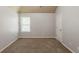 This bedroom features neutral paint, and a window with natural light, and door at 3912 Margaux Dr, Atlanta, GA 30349