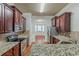 View of kitchen with stainless steel appliances, granite countertops and dark wood cabinets at 3912 Margaux Dr, Atlanta, GA 30349