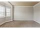 Spacious room with large windows, neutral carpet and base molding at 3912 Margaux Dr, Atlanta, GA 30349