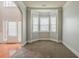 Carpeted room with a bay window and adjacent arched doorway at 3912 Margaux Dr, Atlanta, GA 30349
