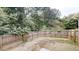 Spacious backyard with a wood fence and views of mature trees at 5246 Salem Springs Pl, Lithonia, GA 30038