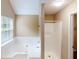 Bright bathroom featuring a large soaking tub with shower at 5246 Salem Springs Pl, Lithonia, GA 30038
