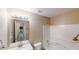 Bright bathroom featuring a white vanity, mirror, and shower-tub combination at 5246 Salem Springs Pl, Lithonia, GA 30038