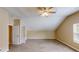 Spacious attic bedroom with sloped ceilings, carpeted floors, and ceiling fan with light at 5246 Salem Springs Pl, Lithonia, GA 30038
