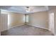 Spacious bedroom featuring neutral walls, carpeted flooring, a ceiling fan, and a tray ceiling at 5246 Salem Springs Pl, Lithonia, GA 30038