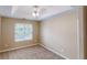 Sunlit bedroom with neutral walls, plush carpet, and a ceiling fan at 5246 Salem Springs Pl, Lithonia, GA 30038