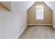 Attic bedroom with a window and neutral colored carpet and paint at 5246 Salem Springs Pl, Lithonia, GA 30038