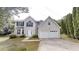Charming two-story home with a double garage and well-maintained lawn at 5246 Salem Springs Pl, Lithonia, GA 30038