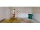 View of the garage area, showing an exit door and recycling bin at 5246 Salem Springs Pl, Lithonia, GA 30038