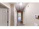 Hallway view with neutral paint and carpeted floors leads to a naturally lit room at 5246 Salem Springs Pl, Lithonia, GA 30038