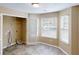 Bright laundry room with tile flooring, window, and closet at 5246 Salem Springs Pl, Lithonia, GA 30038