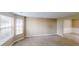 Bright living room featuring large windows and neutral carpeting, creating a warm and inviting atmosphere at 5246 Salem Springs Pl, Lithonia, GA 30038
