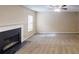 Spacious living room with neutral carpet, fireplace, and ceiling fan at 5246 Salem Springs Pl, Lithonia, GA 30038