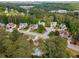Aerial view of a neighborhood showcases beautiful homes surrounded by mature trees and lush landscaping at 825 Yosemite Dr, Suwanee, GA 30024
