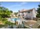 Backyard with a gunite pool, outdoor dining area, and lush greenery at 825 Yosemite Dr, Suwanee, GA 30024
