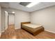 Bedroom with vinyl wood floors contains bed frame and a doorway to another room at 825 Yosemite Dr, Suwanee, GA 30024