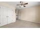 Bedroom with a ceiling fan, double closet doors, and a neutral carpet at 825 Yosemite Dr, Suwanee, GA 30024