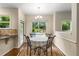 Cozy dining nook with backyard views, featuring a chandelier and seating for four at 825 Yosemite Dr, Suwanee, GA 30024
