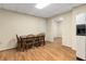 A small dining area has wood floors, wood table and chairs, and a nearby refrigerator at 825 Yosemite Dr, Suwanee, GA 30024