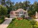 Inviting home with mature landscaping, a two-car garage, brick facade, and a covered entryway at 825 Yosemite Dr, Suwanee, GA 30024