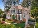 Charming two-story home featuring a brick and siding exterior, landscaped front yard, and inviting front porch at 825 Yosemite Dr, Suwanee, GA 30024