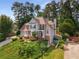 Beautiful home with mature trees, manicured lawn, brick accents, and a welcoming two-story facade at 825 Yosemite Dr, Suwanee, GA 30024