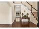 Elegant foyer with hardwood floors, staircase, and views into adjacent rooms filled with natural light at 825 Yosemite Dr, Suwanee, GA 30024