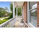 The home's brick facade and front porch create a welcoming outdoor space for relaxation and socializing at 825 Yosemite Dr, Suwanee, GA 30024