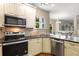 Well-equipped kitchen with stainless steel appliances and dark countertops adjacent to a dining area at 825 Yosemite Dr, Suwanee, GA 30024